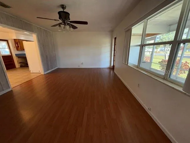 a view of a livingroom with a ceiling fan and window