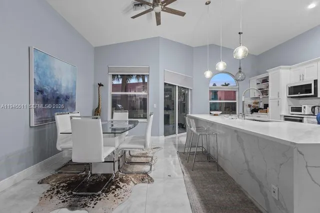 a large white kitchen with a table and chairs