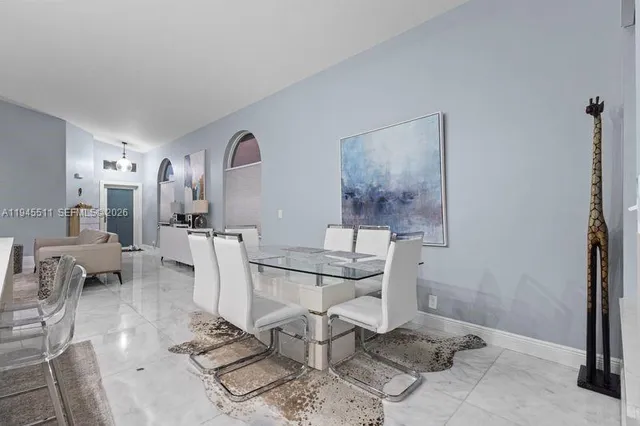 a living room with furniture a rug and white walls