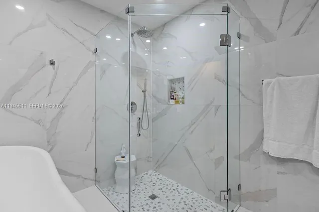 a bathroom with a shower and a shower