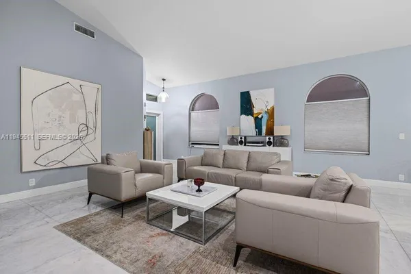 a living room with furniture and a large window