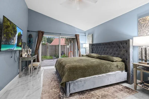 a bed sitting in a bedroom next to a window