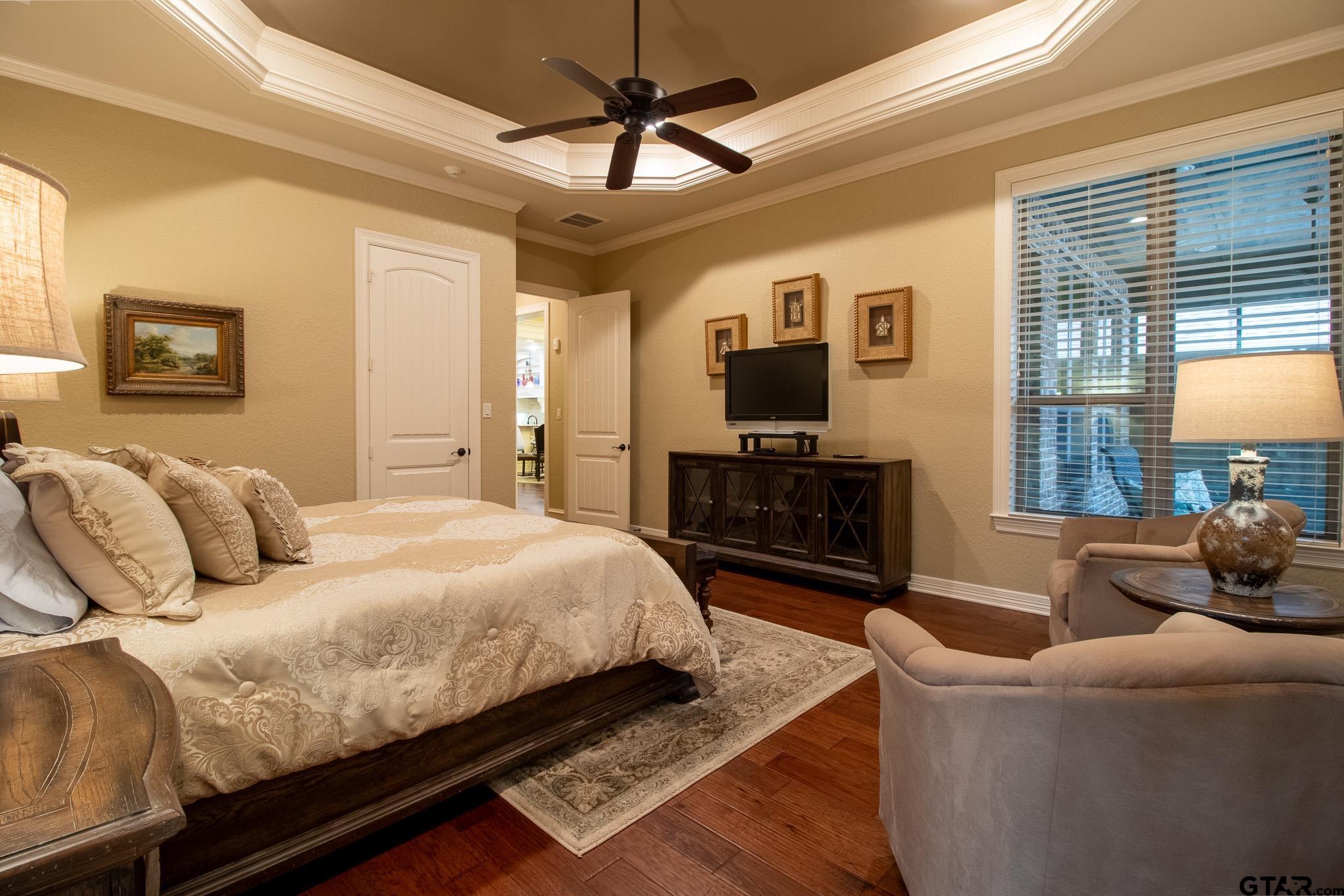 7315 Princedale Tyler, TX 75703 - Photo 15 of 25 a bedroom with a bed a couch and a flat screen tv