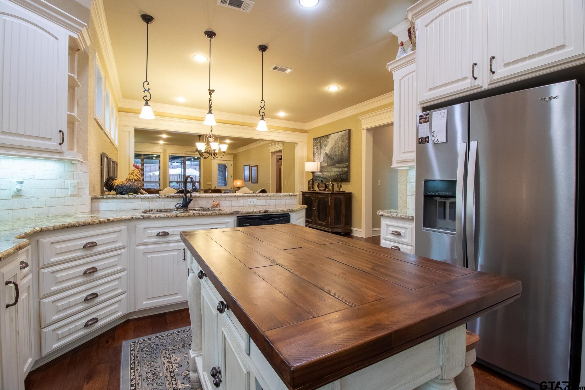 7315 Princedale Tyler, TX 75703 - Photo 17 of 25 a kitchen with stainless steel appliances granite countertop a sink refrigerator and cabinets