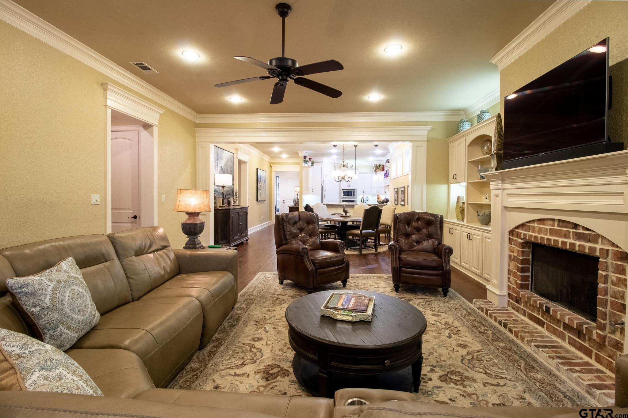 7315 Princedale Tyler, TX 75703 - Photo 22 of 25 a living room with furniture a fireplace and a flat screen tv