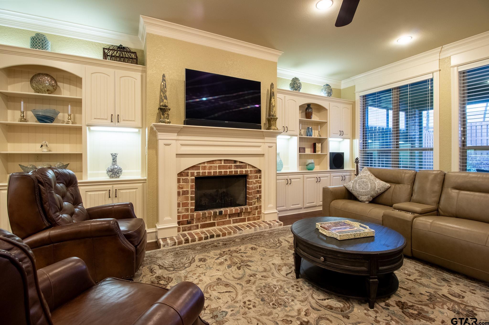 7315 Princedale Tyler, TX 75703 - Photo 10 of 25 a living room with furniture a flat screen tv and a fireplace