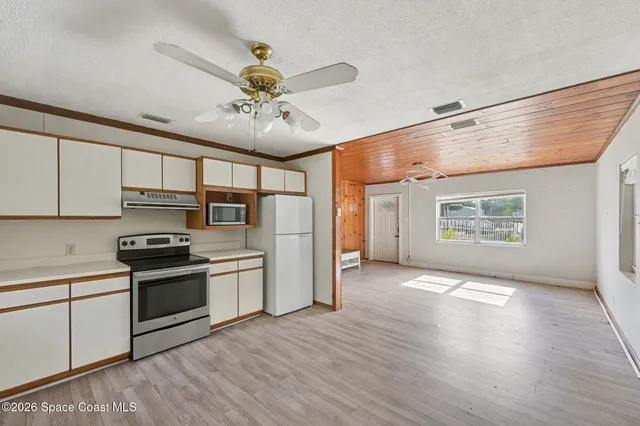 a kitchen with stainless steel appliances granite countertop a stove and a refrigerator