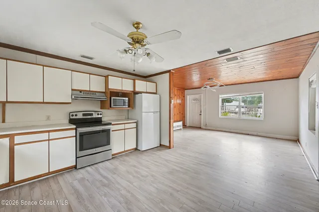 a kitchen with stainless steel appliances a stove a refrigerator and cabinets