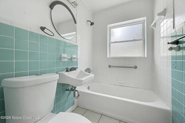a bathroom with a toilet a sink and bathtub