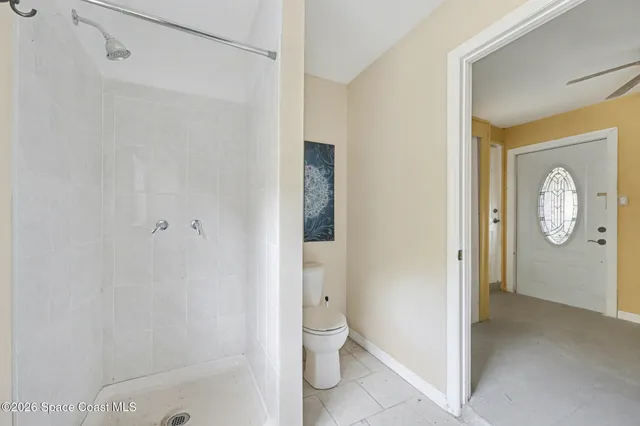 a bathroom with a shower and a toilet