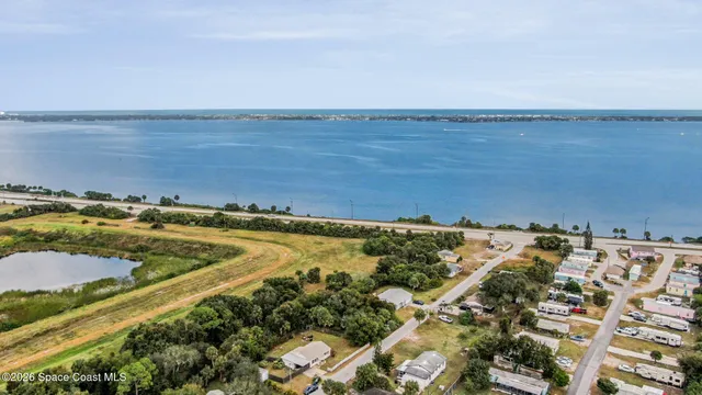 an aerial view of residential building and ocean