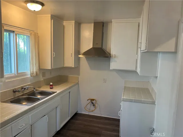 a kitchen with a sink and a stove top oven