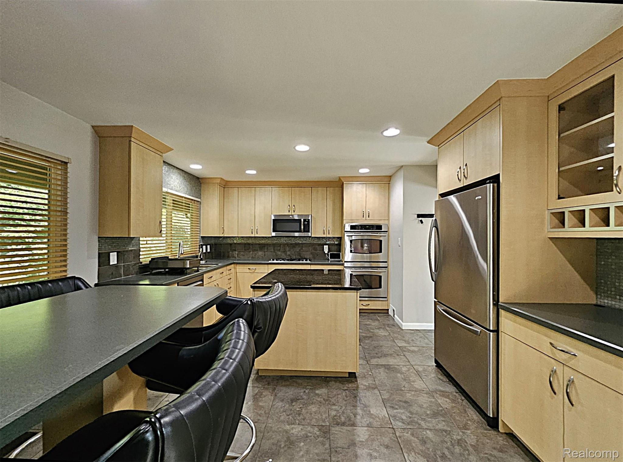 7120 Pebblecreek Road West Bloomfield, MI 48322 - Photo 16 of 31 Kitchen featuring light wood cabinetry, dark countertops, and stainless steel appliances