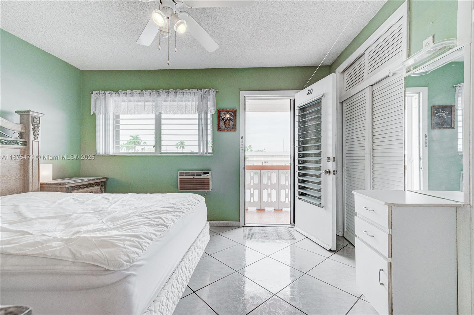 800 Southwest 10th Terrace, Unit 20T Hallandale Beach, FL 33009 - Photo 14 of 28 a bedroom with a large bed and a window
