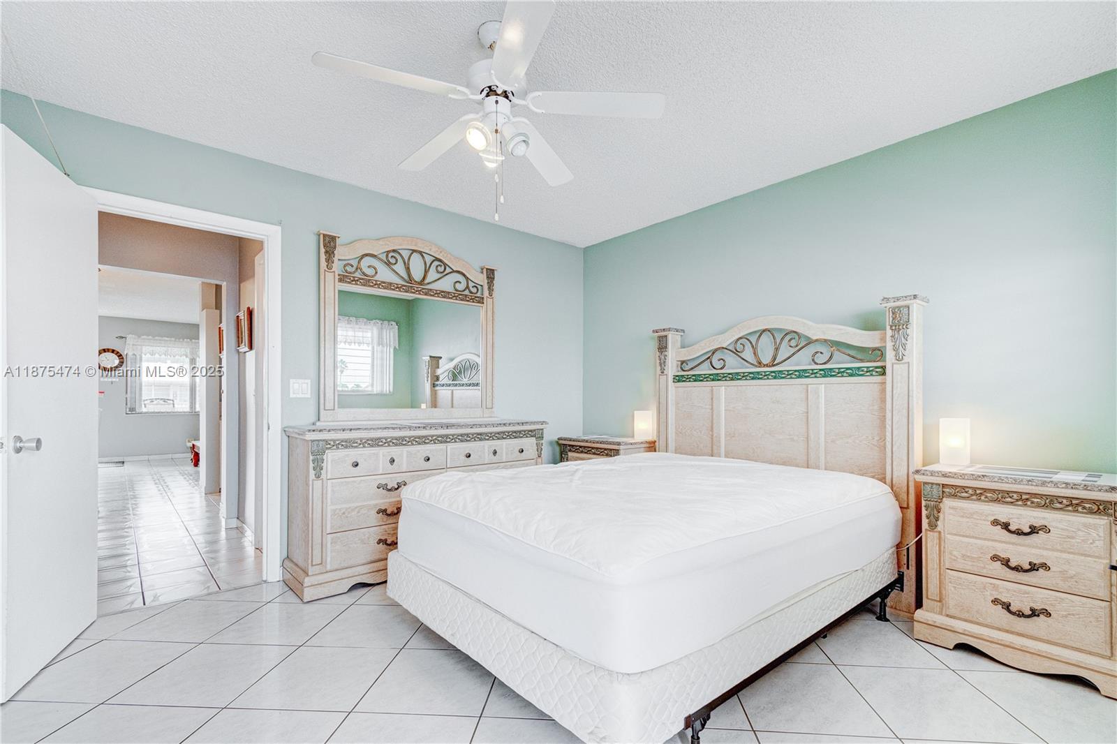 800 Southwest 10th Terrace, Unit 20T Hallandale Beach, FL 33009 - Photo 15 of 28 a bedroom with a bed and a chandelier