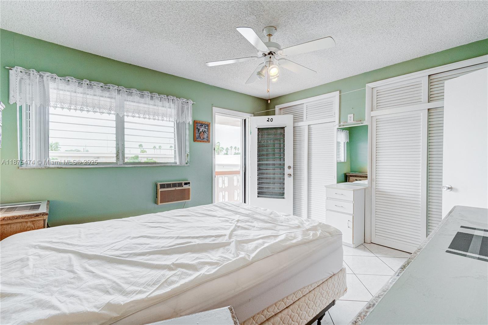 800 Southwest 10th Terrace, Unit 20T Hallandale Beach, FL 33009 - Photo 17 of 28 a bedroom with a large bed and a chandelier