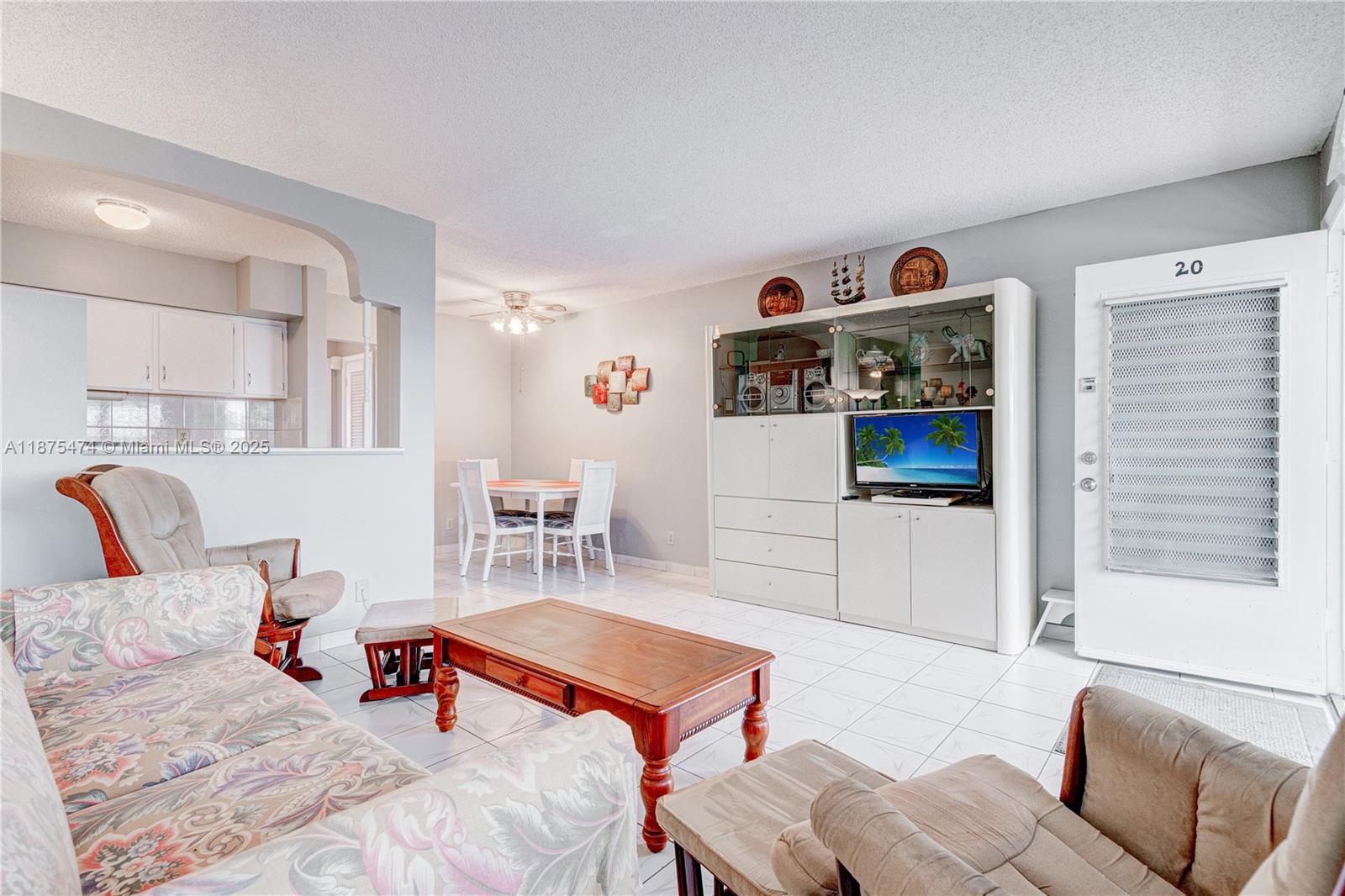 800 Southwest 10th Terrace, Unit 20T Hallandale Beach, FL 33009 - Photo 3 of 28 a bedroom with furniture and a flat screen tv