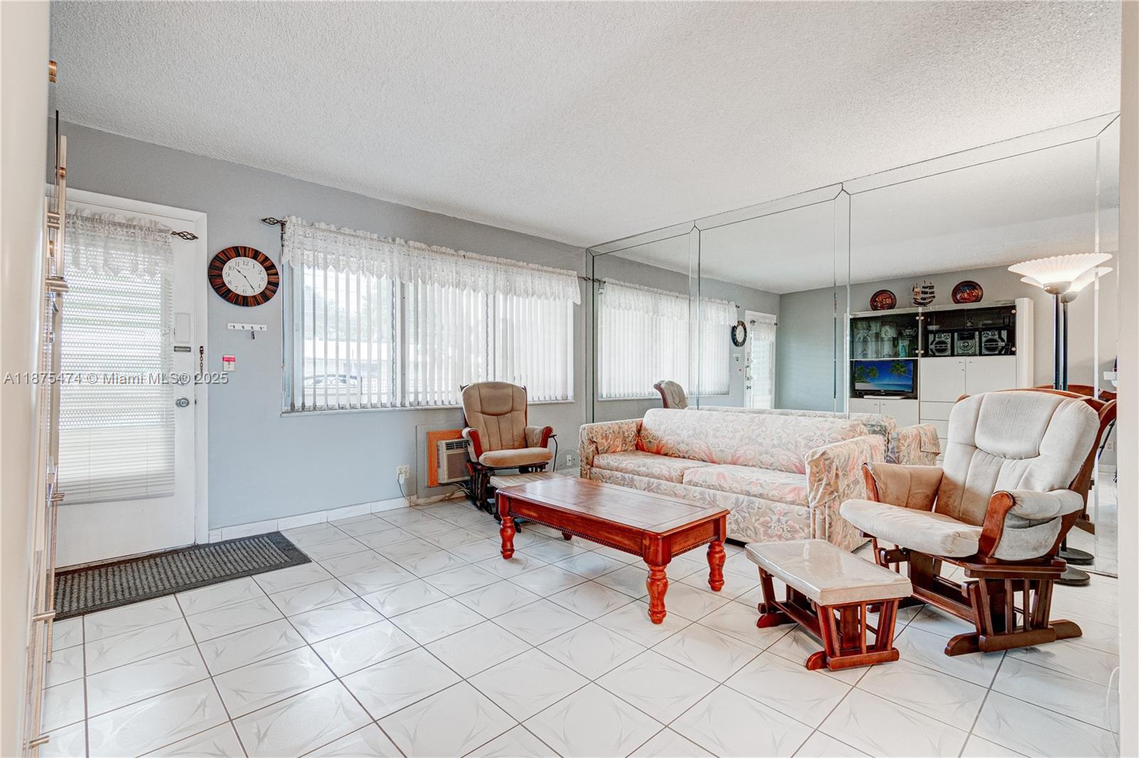 800 Southwest 10th Terrace, Unit 20T Hallandale Beach, FL 33009 - Photo 5 of 28 a living room with furniture and a window