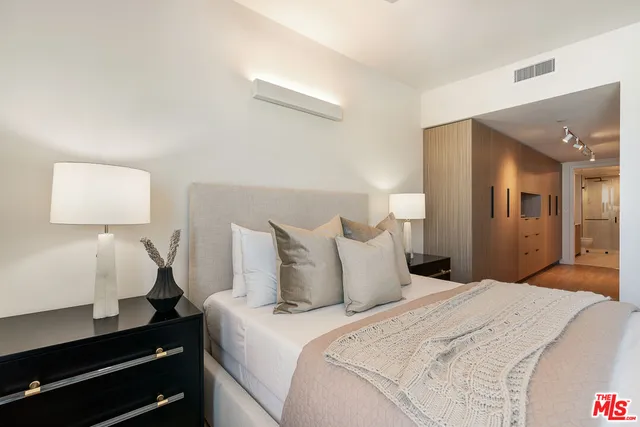 a bedroom with a bed and a lamp on table