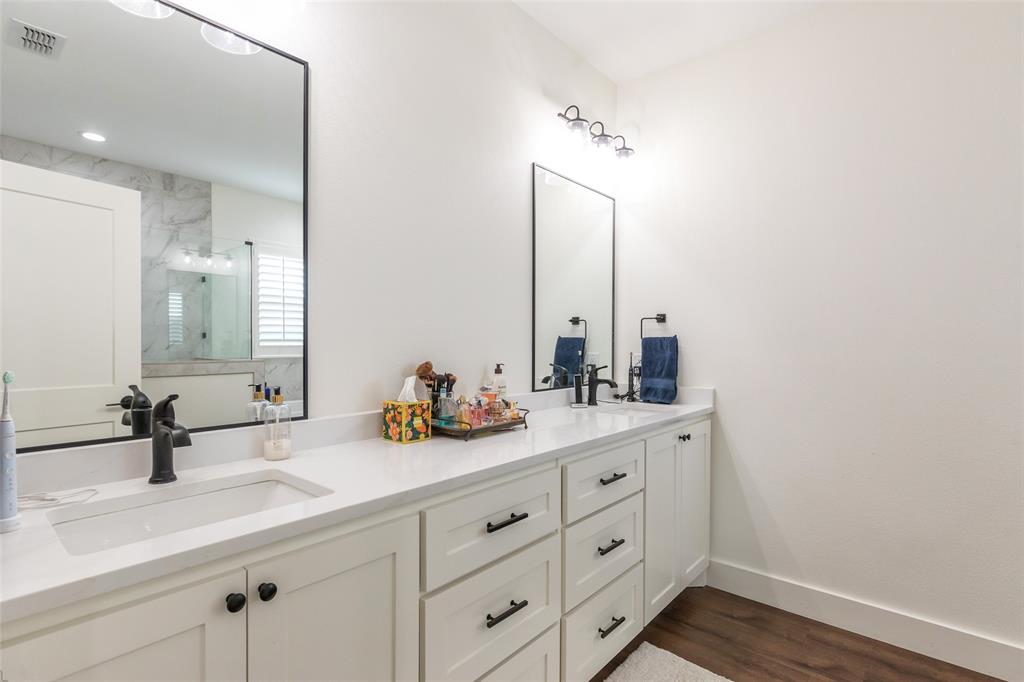 143 Purcell Lane Tuscola, TX 79562 - Photo 21 of 35 a bathroom with a double vanity sink and mirror