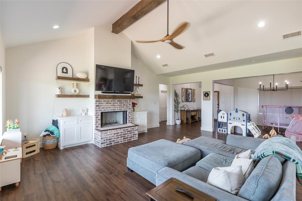 143 Purcell Lane Tuscola, TX 79562 - Photo 10 of 35 a living room with furniture a fireplace and a flat screen tv