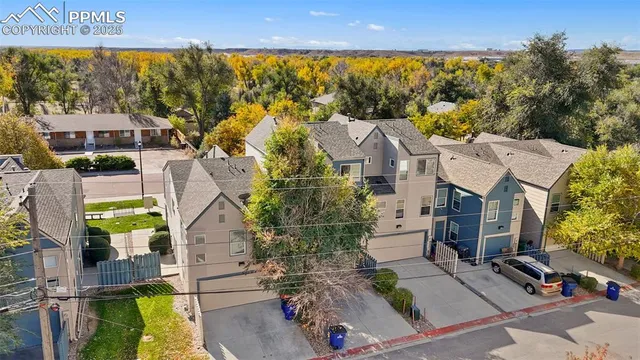 an aerial view of multiple houses with a yard