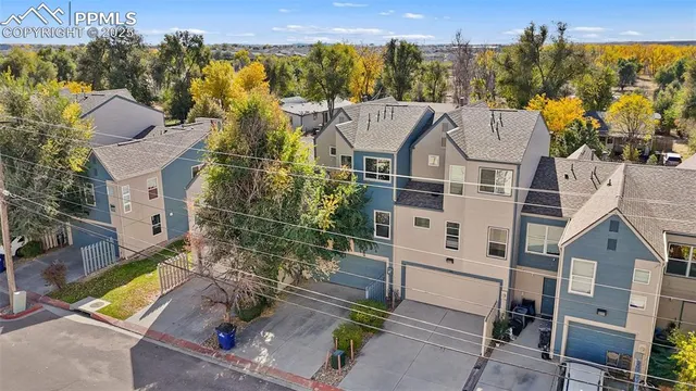 an aerial view of residential houses with outdoor space and swimming pool