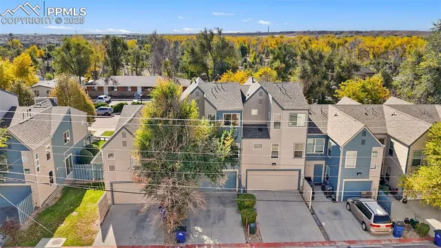 an aerial view of a house with a yard and potted plants