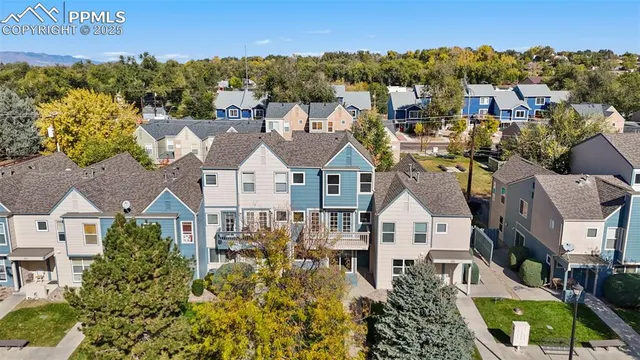 an aerial view of residential houses with outdoor space