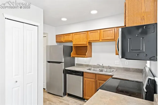 a kitchen with stainless steel appliances granite countertop a sink stove and microwave