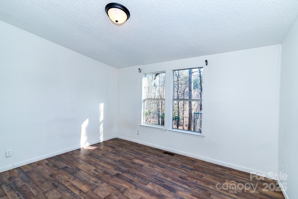 7368 Martins Creek Road Murphy, NC 28906 - Photo 13 of 21 an empty room with wooden floor and windows