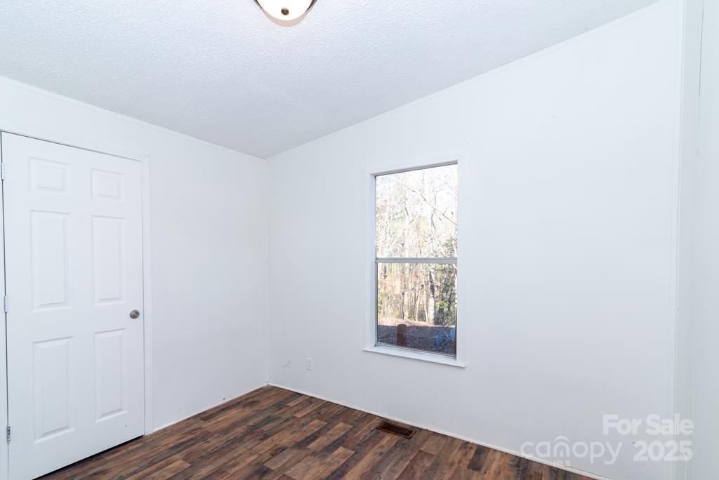 7368 Martins Creek Road Murphy, NC 28906 - Photo 14 of 21 an empty room with wooden floor and windows