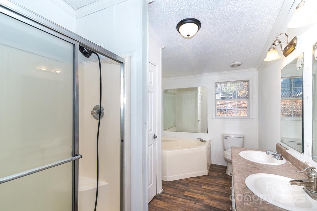 7368 Martins Creek Road Murphy, NC 28906 - Photo 16 of 21 a bathroom with a bathtub shower sink vanity and toilet