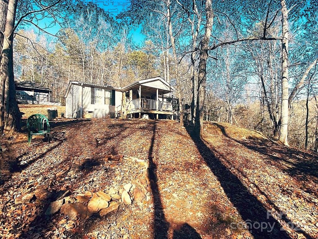 7368 Martins Creek Road Murphy, NC 28906 - Photo 7 of 21 a view of a large yard with a fountain and a large tree
