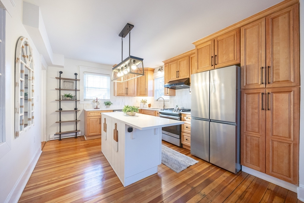 42 York Street Andover, MA 01810 - Photo 12 of 35 a kitchen with stainless steel appliances granite countertop a refrigerator a stove and a wooden floors