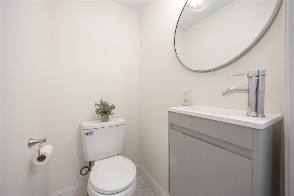 42 York Street Andover, MA 01810 - Photo 13 of 35 a bathroom with a toilet sink and mirror