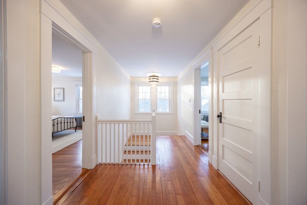 42 York Street Andover, MA 01810 - Photo 14 of 35 a view of a hallway with wooden floor and a bathroom