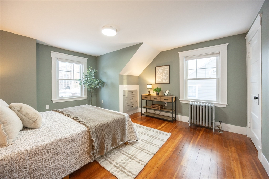 42 York Street Andover, MA 01810 - Photo 16 of 35 a spacious bedroom with a bed a dresser and wooden floor