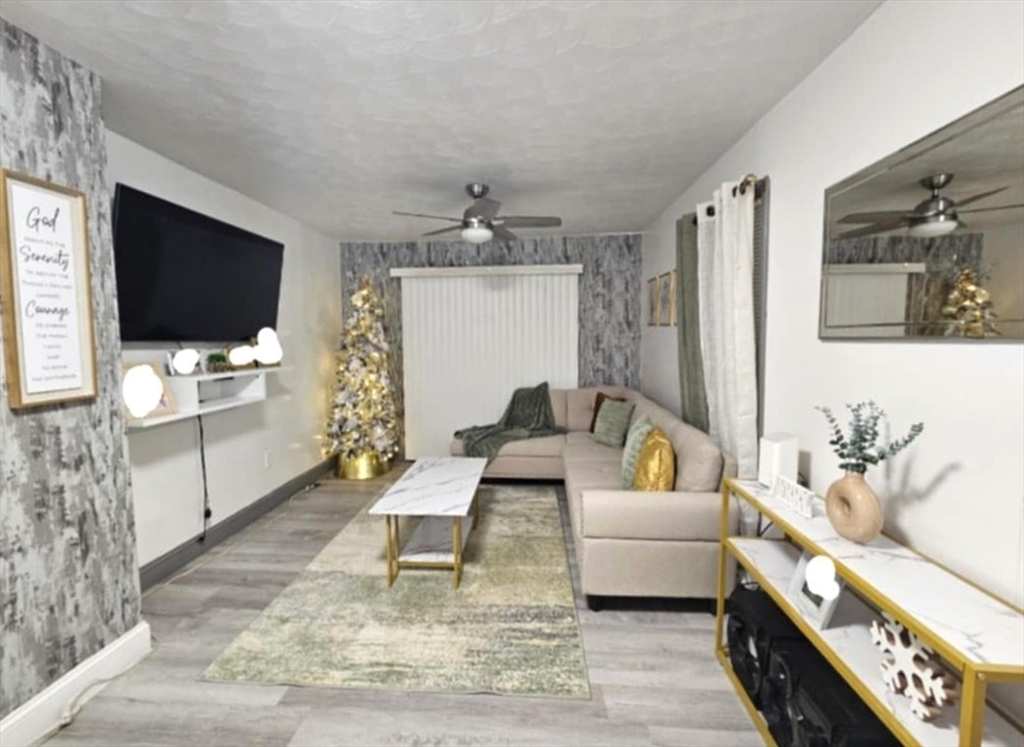 56 Montclair Street Springfield, MA 01104 - Photo 3 of 8 a living room with furniture and a flat screen tv