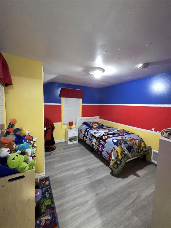 56 Montclair Street Springfield, MA 01104 - Photo 6 of 8 a bedroom with bed and a potted plant