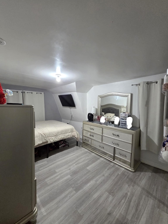 56 Montclair Street Springfield, MA 01104 - Photo 7 of 8 a bedroom with furniture and a wooden floor