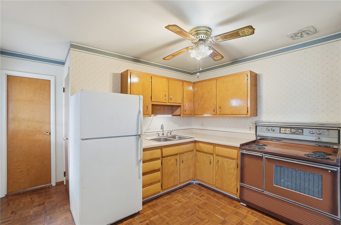 1087 Fairfield Road Troy, OH 45373 - Photo 12 of 39 This bright kitchen offers a functional layout and ample cabinetry, ready for your culinary endeavors.