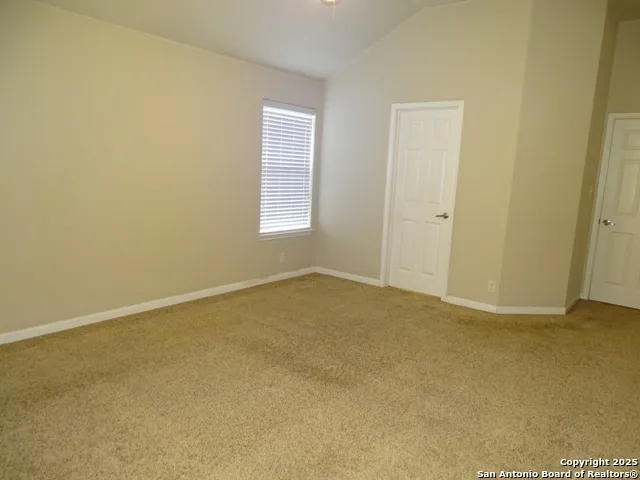 a view of an empty room and a window
