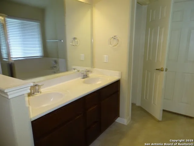 a bathroom with a sink double vanity and a mirror