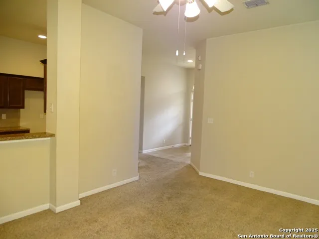 a view of hallway with a bathroom