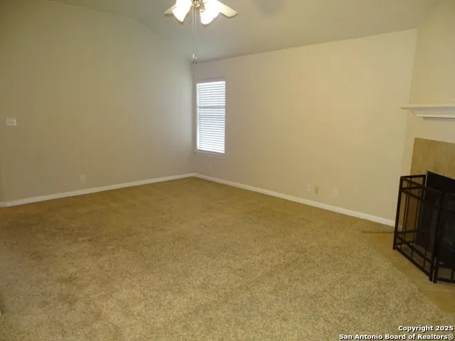 an empty room with a fireplace