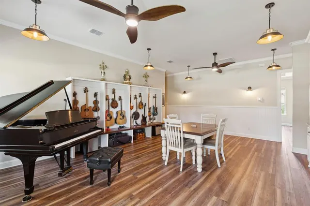 a dining room with furniture entryway and wooden floor