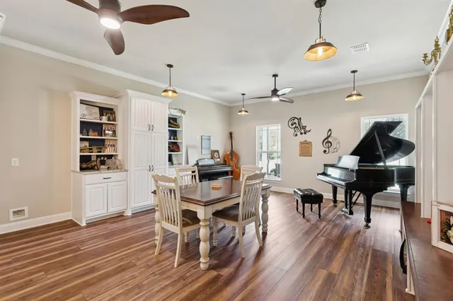 a view of a dining room with furniture and wooden floor