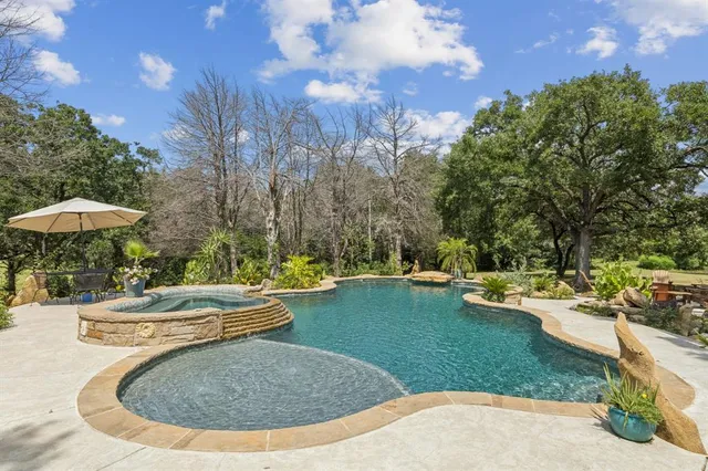 a view of a swimming pool with a patio