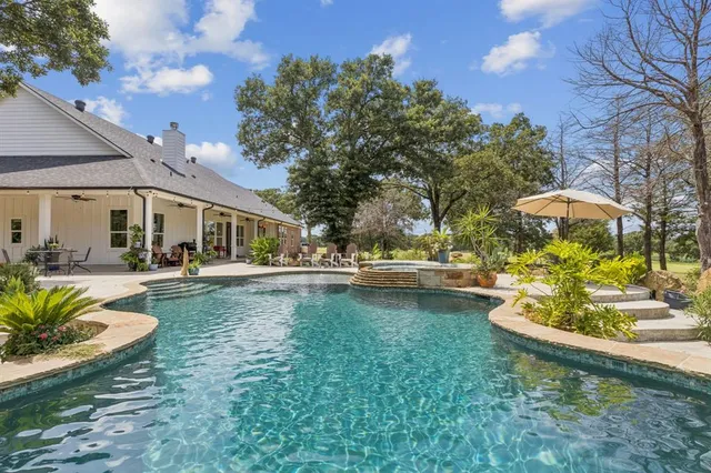 a view of a swimming pool with lounge chair